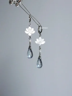 Clear lotus drop Hanfu earrings with carved white shell flower charms faux pearl accents smoky blue glass teardrops and silver hook ear wires