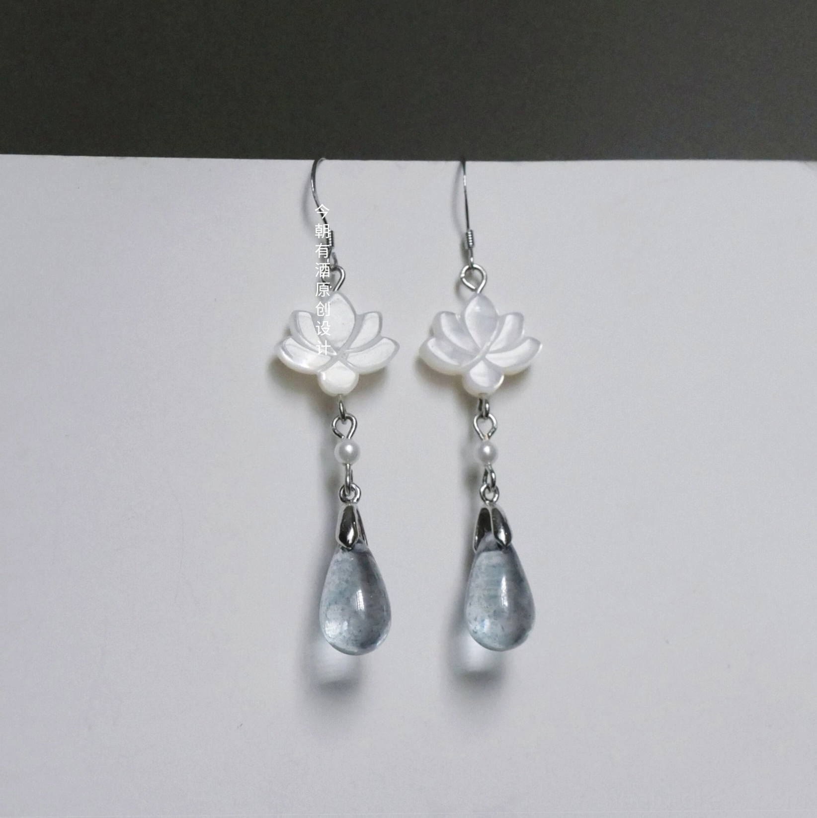 White lotus and smoky blue glass drop earrings with silver hook ear wires inspired by traditional Chinese Hanfu jewelry