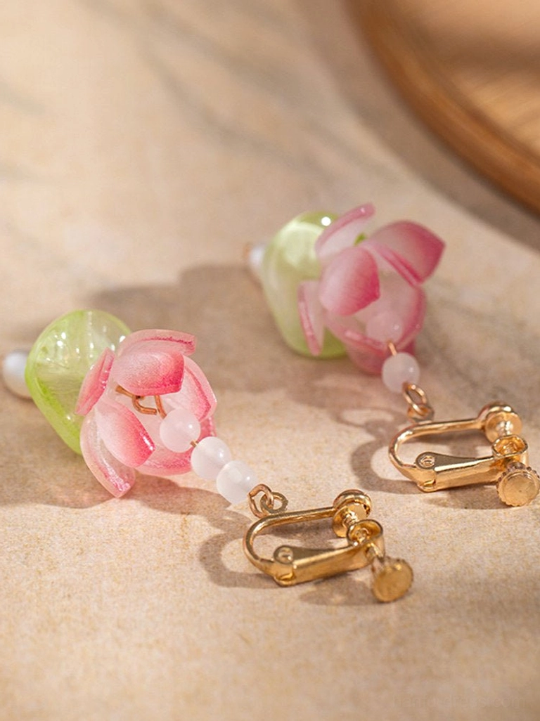 Clip-on lotus hanfu earrings with gold comfort clip fasteners, pink resin lotus charms, green beads, and freshwater pearl pendants