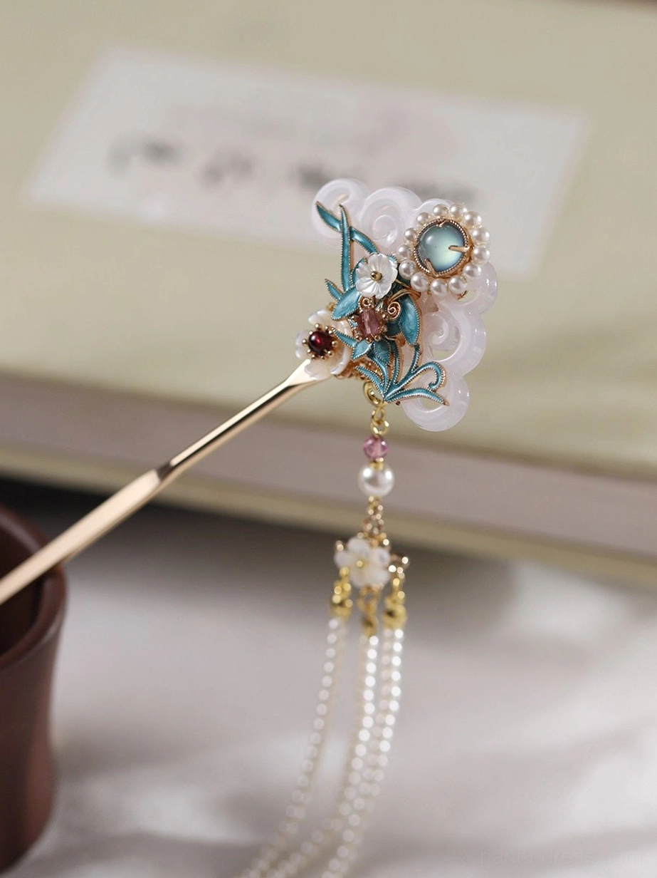 Orchid themed Chinese hair stick for Hanfu featuring blue enamel-style leaves, white shell-like decorative accents and a flower charm tassel