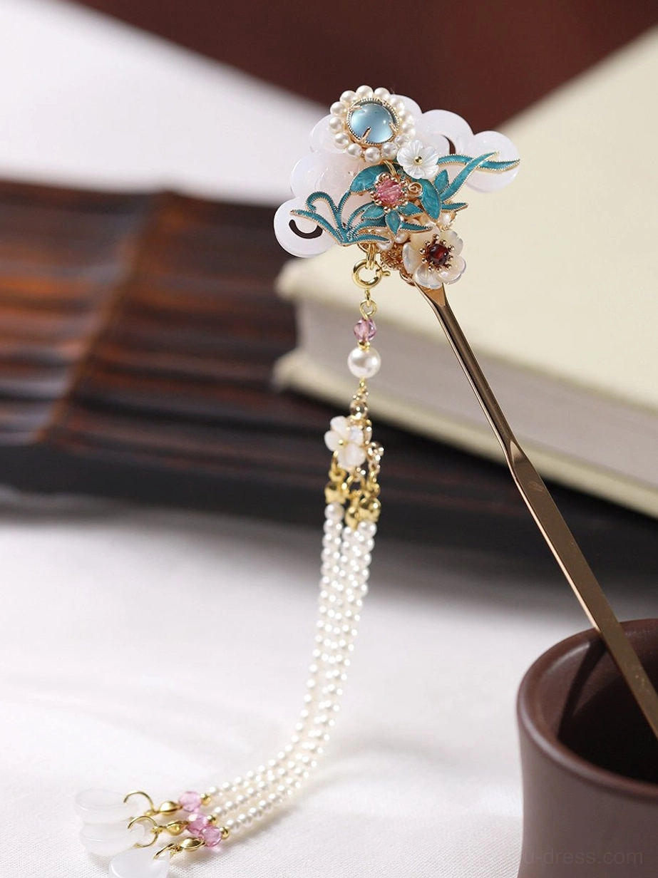 Close detailed view of pearl-style tassel and gold filigree-inspired pendant on a traditional Chinese cloisonne orchid hair stick