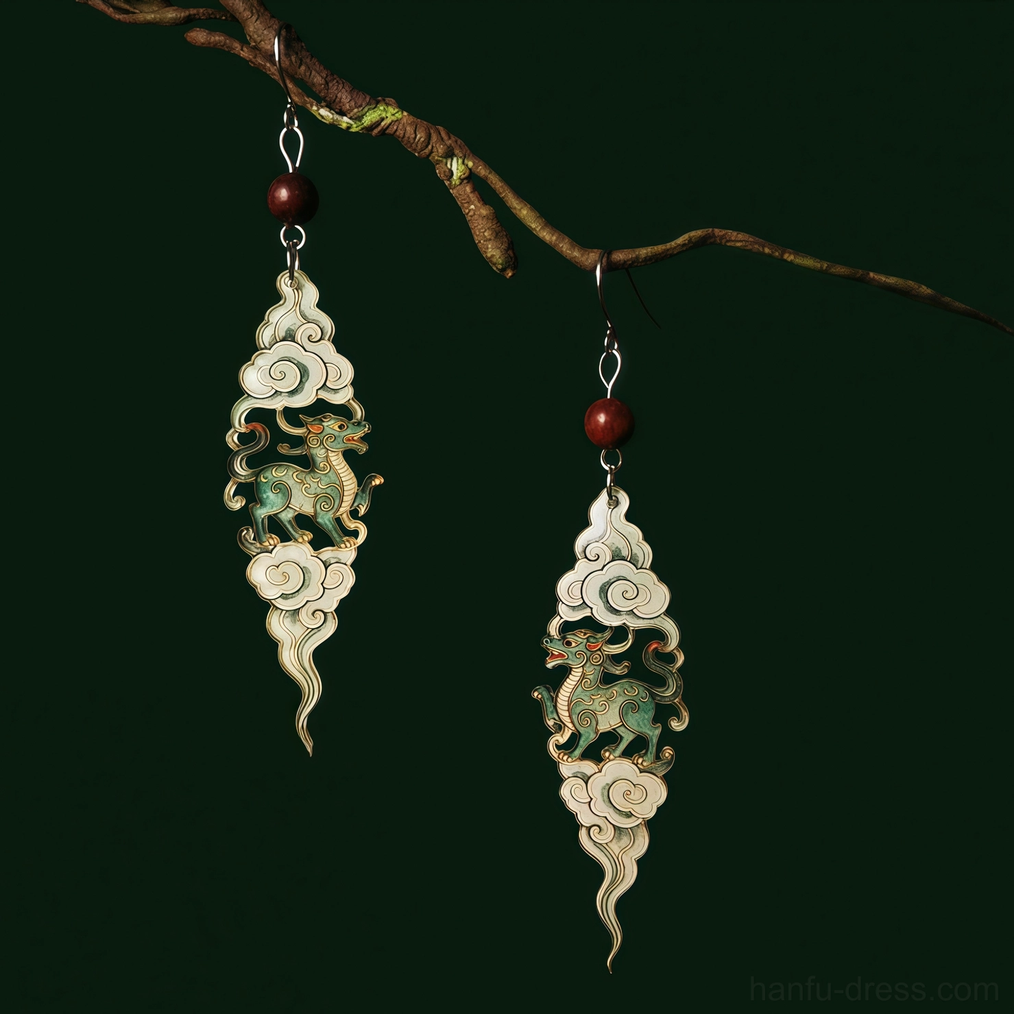 Close up view of Chinese Qilin mythology earrings with auspicious cloud pendants green antique finish red beads and silver earring hooks