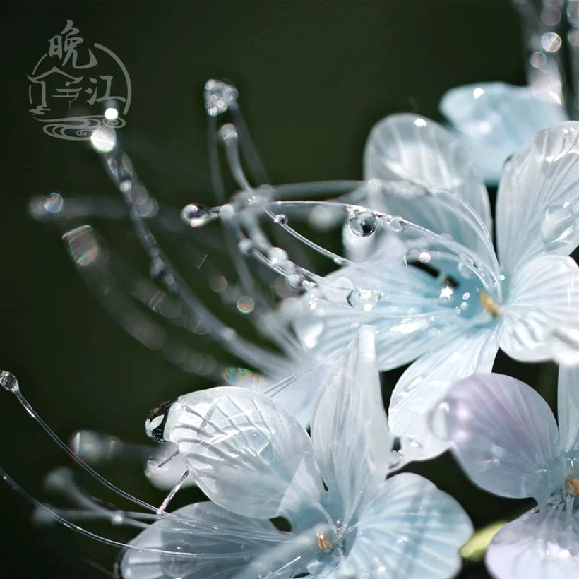 Close-up of translucent blue and light purple flower petals with realistic vein textures and clear water drop ornaments on a Chinese hair stick