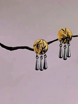 Close-up Chinese bamboo stud dangle earrings with hand-painted black bamboo round charms and three elegant silver teardrop hanging charms