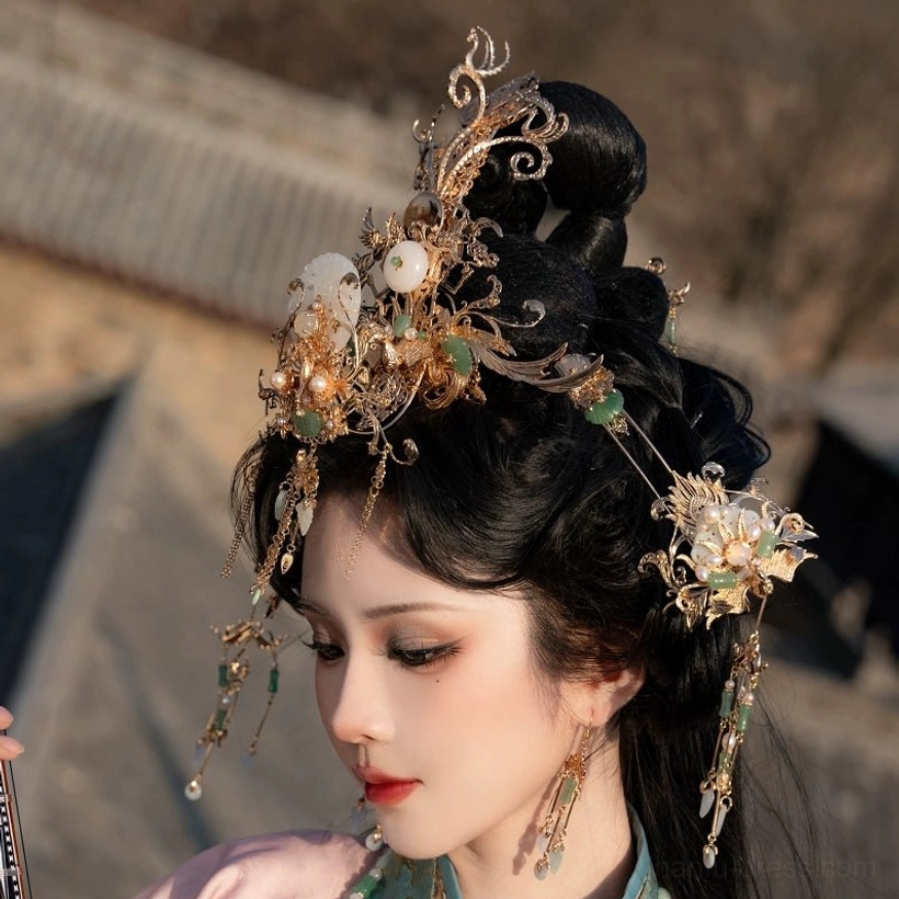Close-up side portrait of a woman wearing gold filigree hanfu hair ornaments tassel hairpins and matching earrings with an ancient Chinese architectural background