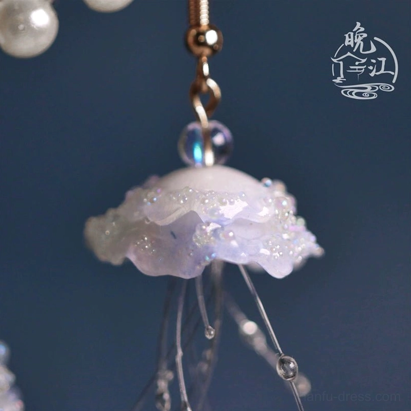 Close-up side view of a single jellyfish drop earring featuring a micro-beaded iridescent cap delicate transparent tentacles and fine handcrafted beadwork