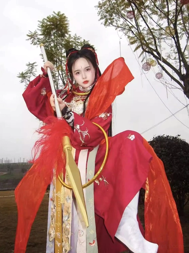 Close-up of a red Nezha male Hanfu cosplay outfit with gold decorative details layered sashes and traditional Chinese fantasy styling
