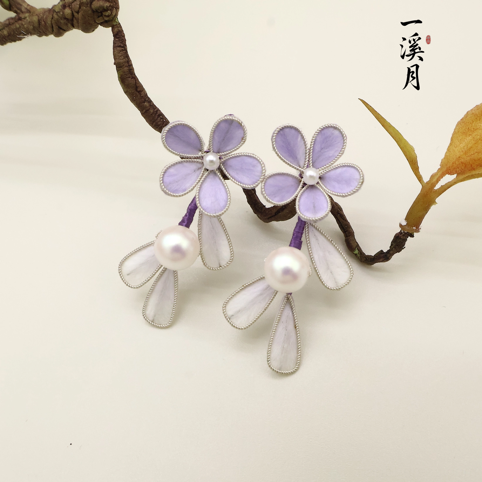 Close-up of smoke purple flower pearl drop earrings showing detailed fabric petals, silver edging, glossy pearl centers, and delicate translucent Chinese jewelry charms