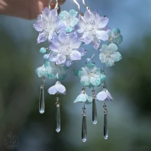 Cloud and mist floral Chinese hair stick close-up with purple and cyan flowers, clear teardrop tassels, and silver-toned details