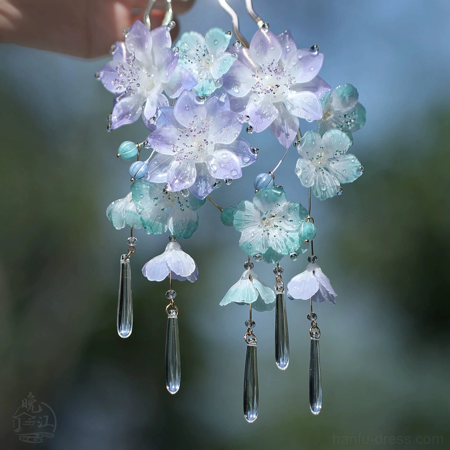 Cloud and mist floral Chinese hair stick close-up with purple and cyan flowers, clear teardrop tassels, and silver-toned details
