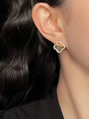 Woman wearing clover hollow lattice stud earrings on the ear, elegant Chinese earrings for Cheongsam and modern outfits