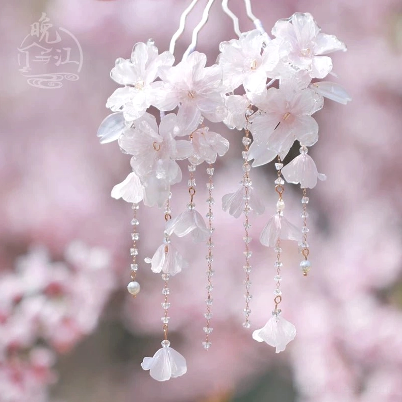 Front view of a cluster cherry blossom Chinese hair stick featuring pink floral groups a light metal stem and multiple hanging tassels
