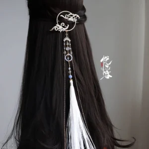 Cold Moon Chinese Hanfu back hair pin worn on long black hair, featuring a gold-tone cloud frame, white tassel, pale blue beads, and layered dangling ornaments