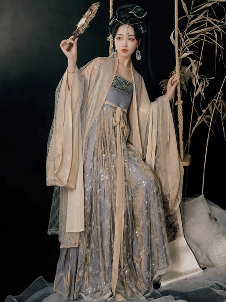 Cold Tangerine Tang Dynasty Hanfu Heziqun dress styled with sheer apricot wide sleeves, sequined lilac skirt, traditional hair ornaments, earrings, and vintage fan