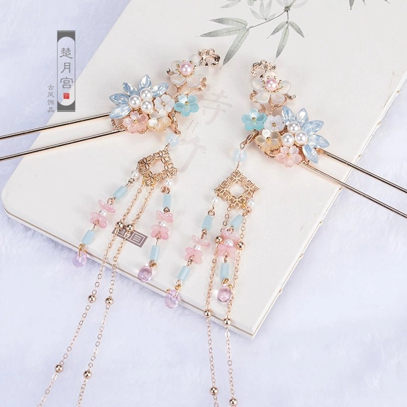 Matching pair of colorful spring hanfu step hairpins with pink and blue flowers, gold-tone metal details, hanging chains, and gradient crystal-look bead tassels