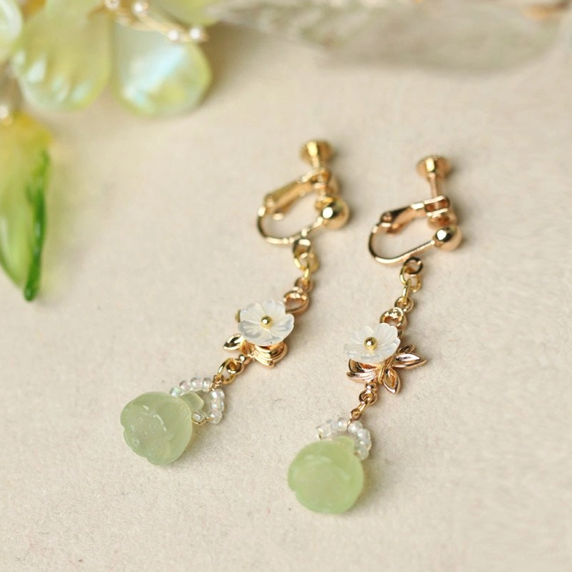 Comfort clip-on Chinese earrings with gold fasteners tiny flower charms clear bead details and round light green lotus pod drops