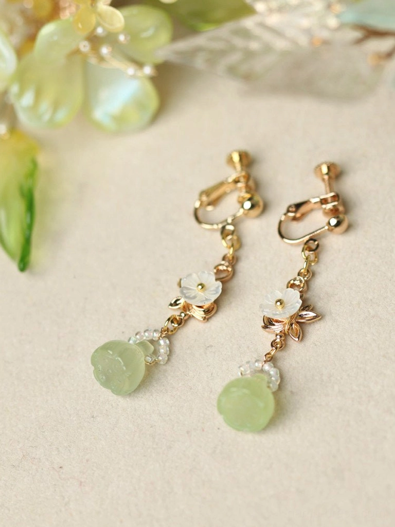 Comfort clip-on lotus pod earrings with gold clip fasteners white flower charms clear beads and light green round pendants