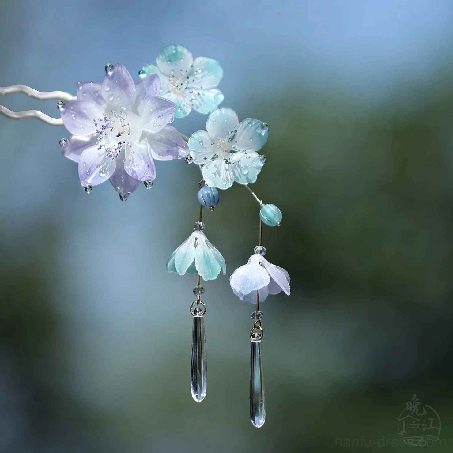 Compact traditional Chinese floral hair stick with purple blue flower cluster, bell-shaped charms, and clear dangling pendants