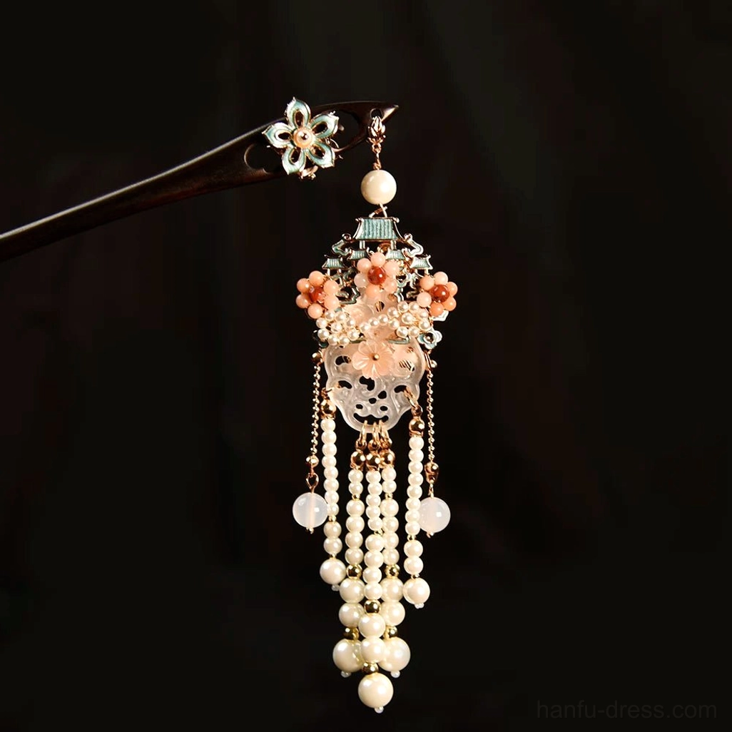 Compact traditional Chinese tassel hair stick with enamel flower decoration, pink floral top ornament, pearl strands, and delicate gold-tone chain tassel shown in close-up