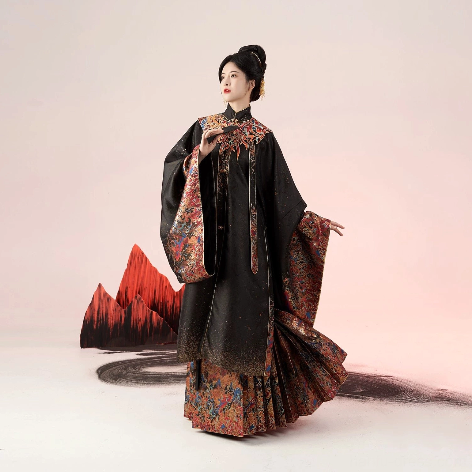 Three-quarter side view of a complete Ming Dynasty Hanfu suit with black and crimson brocade, detachable cloud collar, wide sleeves, and red mountain-inspired studio props