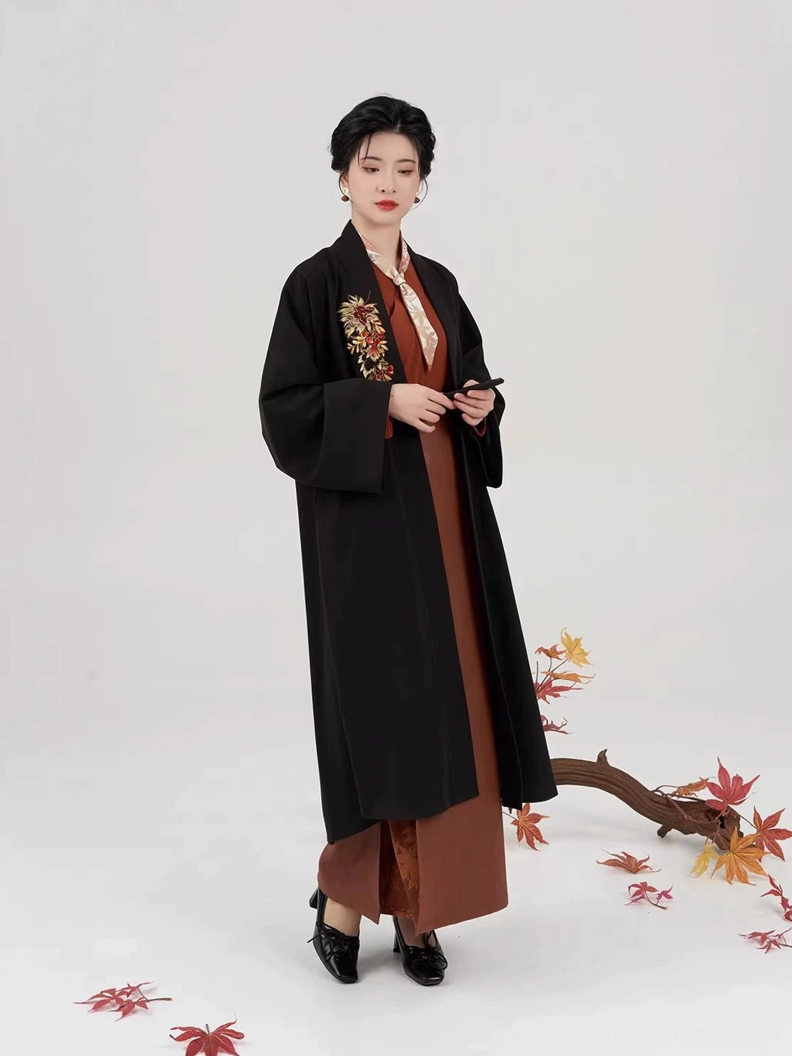 Complete modern Chinese hanfu outfit modeled with a black embroidered jacket, rust-red top, spiral wrap skirt, and layered Song Dynasty styling