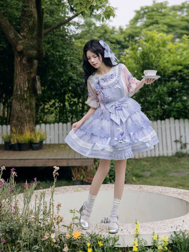 Front three quarter view of a complete modern Hanfu blouse and dress outfit with lavender layered skirt floral prints bows and garden inspired styling
