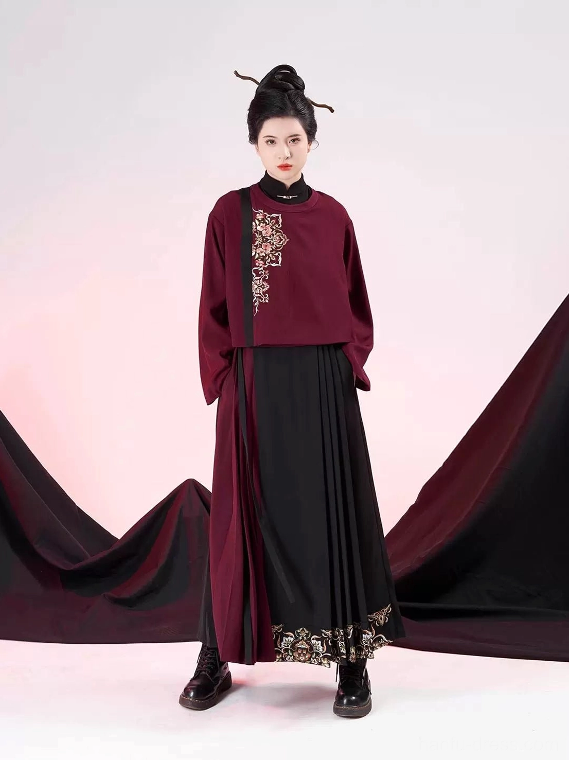 Complete modern Ming Dynasty hanfu outfit styled with traditional hair and black boots, featuring embroidered dark red jacket and black red mamianqun culottes