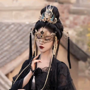 Complete Moon God Hanfu hair accessories set styled with a black traditional Chinese dress, ornate gold crown, teal details, long black tassel hair ornaments, and fantasy face covering in an ancient town