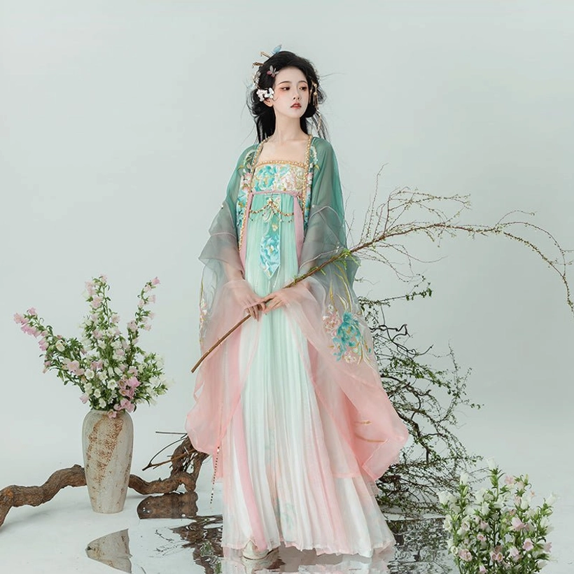 Complete pastel fairy Tang Dynasty Hanfu set shown from the front with pink and green pleated skirt floral chest embroidery and flowing sleeves