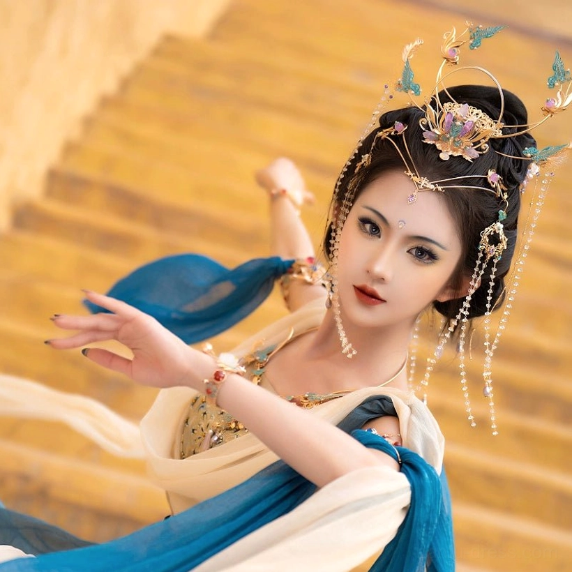 Complete purple Hanfu fairy hair accessory set worn with a Dunhuang flying dancer costume, showing a gilded crown, blue enamel-style details, forehead ornament, and crystal tassels