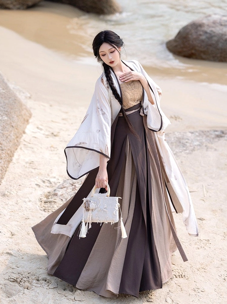Low-angle view of complete modern Hanfu outfit with wide flared sleeves, tailored waist ties, printed beizi jacket, and flowing pleated skirt