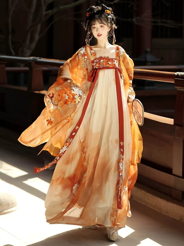 Back three-quarter view of the complete Tang Dynasty Hanfu Heziqun set showing the embroidered back, flowing orange outer coat, wide sleeves, and red sash details