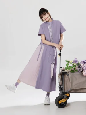 Contemporary Chinese style two piece outfit with cropped stand collar top and A line color block midi skirt shown in a three quarter view