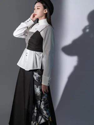 Contemporary Chinese style Hanfu outfit featuring a tailored white stand collar long sleeve shirt, asymmetric black and grey camisole waistcoat, and printed split midi skirt
