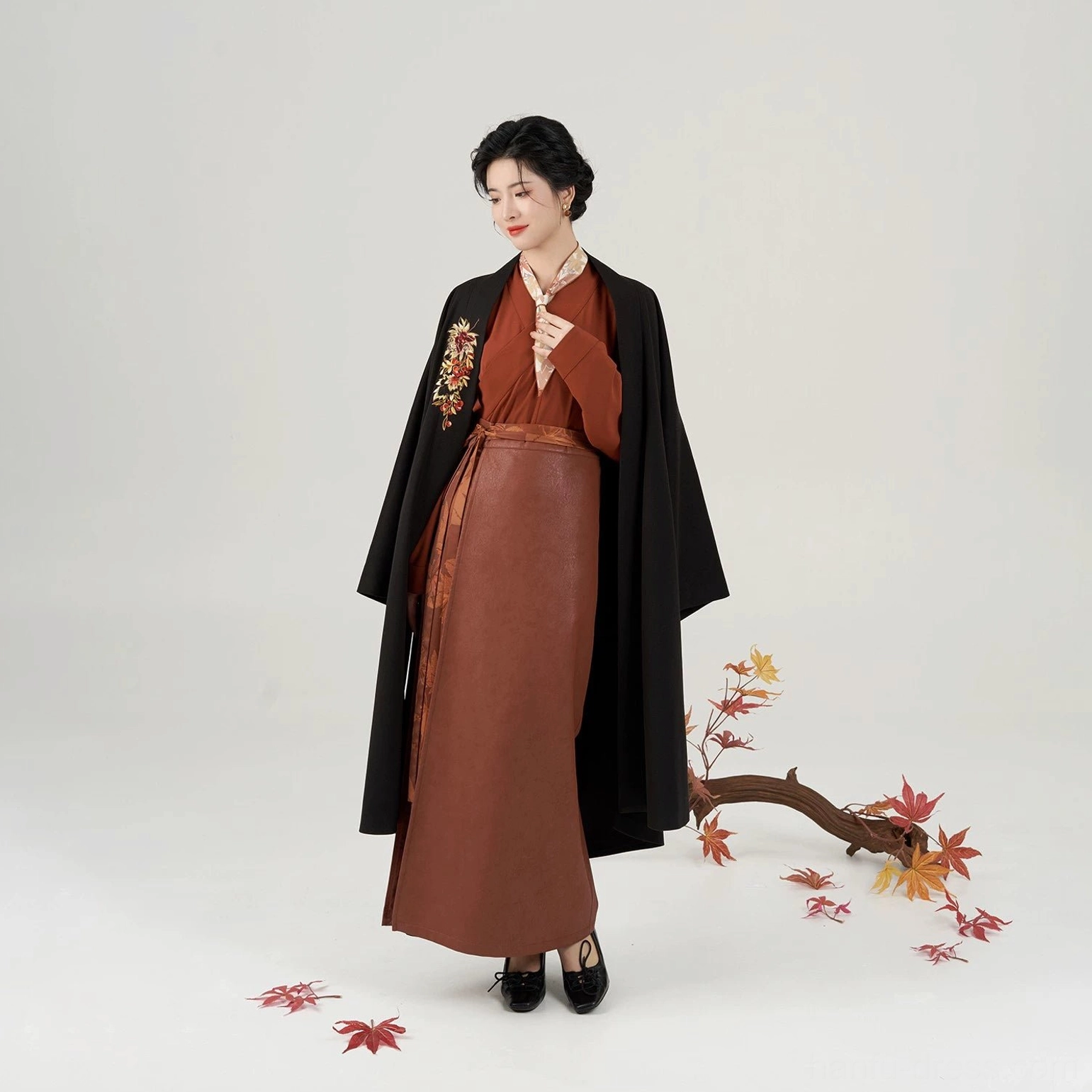 Coordinated modern Song Dynasty hanfu full set shown in a three-quarter front view with black winged-sleeve jacket, rust-red layers, and autumn styling