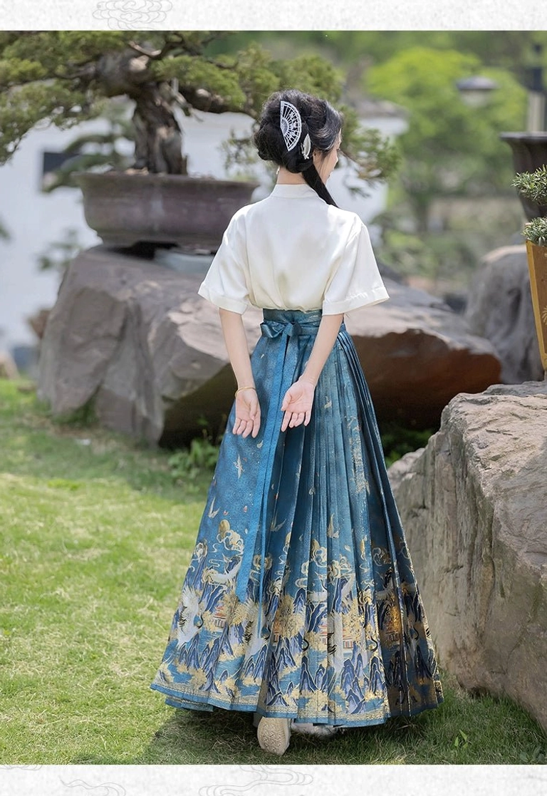 Back view of blue Ming Dynasty inspired mamianqun horse face skirt with waist tie closure and crane landscape hem
