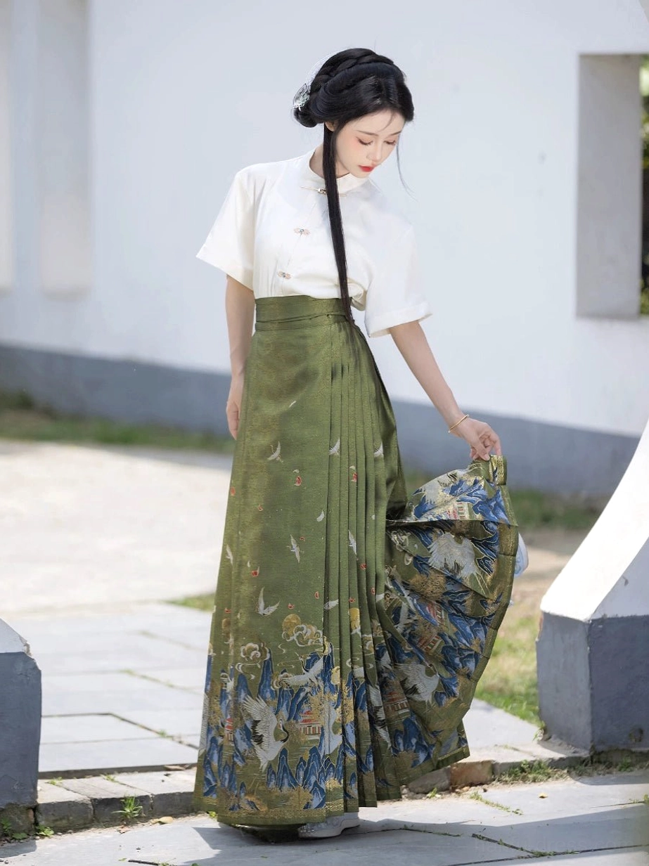 Green Ming Dynasty mamianqun horse face skirt side view showing pleats and crane mountain landscape hem design