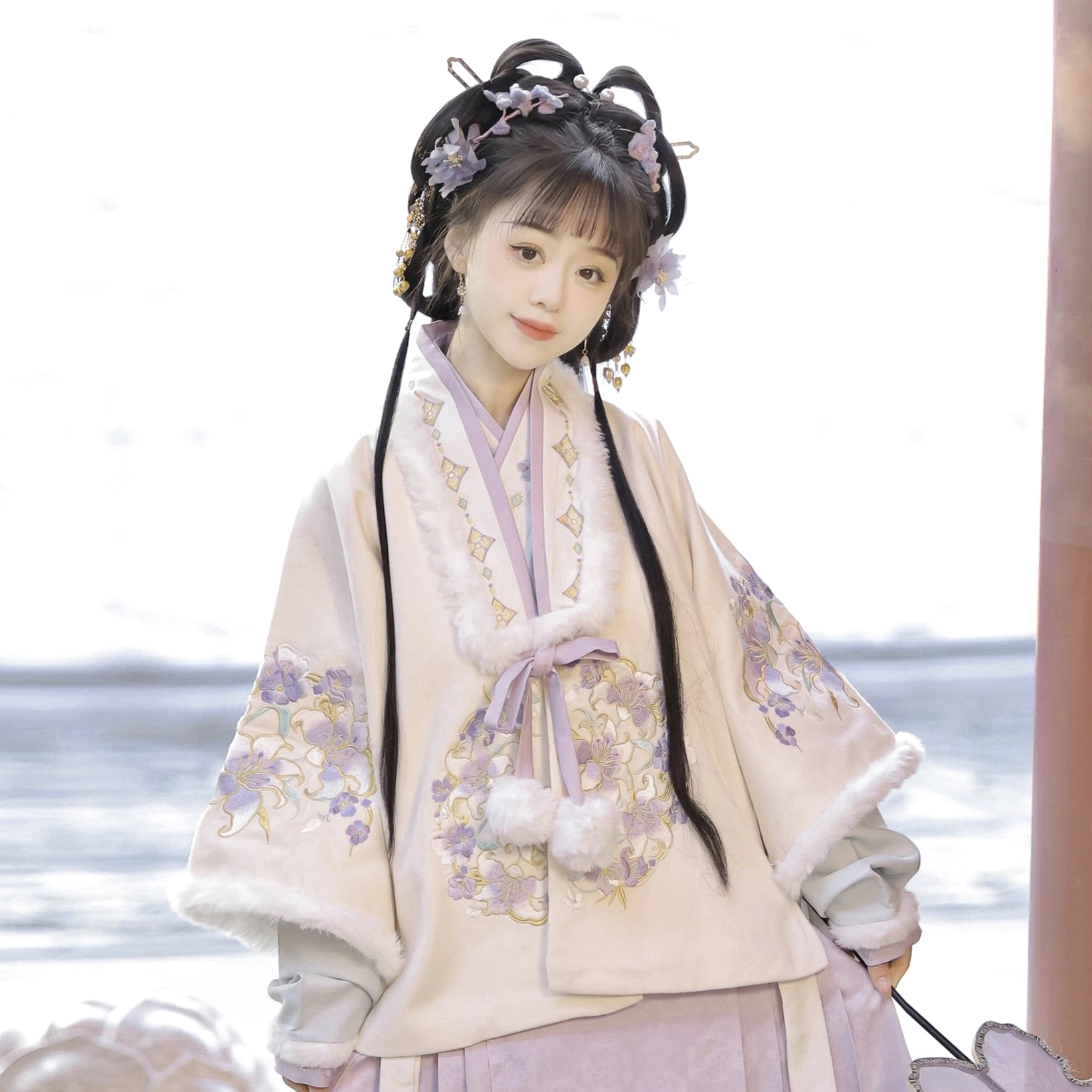 Close-up of cream Ming Dynasty Hanfu cross-collar jacket with purple floral embroidery, soft collar trim, and pink bow detail