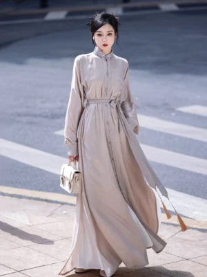 Cream modern Chinese Wuxia Hanfu dress with embroidered stand collar detachable tassel waist sash flowing full length skirt and front button placket worn outdoors