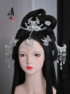 Traditional Chinese bridal hairstyle on mannequin styled with silver-tone filigree hair ornaments, blue accents, forehead tassel and Hanfu-inspired accessories