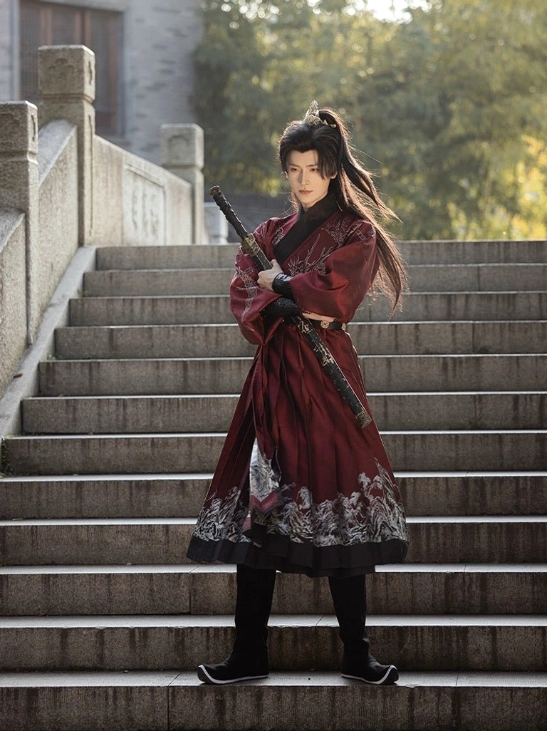 Full-body front view of a man in a crimson Chinese swordsman Hanfu outfit with silver dragon and landscape prints, standing on stone stairs with a sword