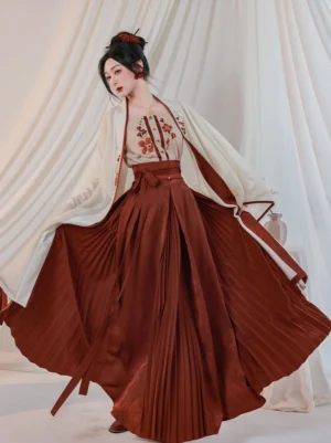 Full body three quarter view of Crimson Cup Song Dynasty Hanfu set with ivory beizi, embroidered camisole, and flowing crimson pleated wrap skirt