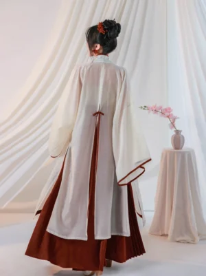 Back view of Crimson Cup modern Song Dynasty Hanfu showing lightweight ivory beizi jacket, dark red back waist ties, and crimson skirt