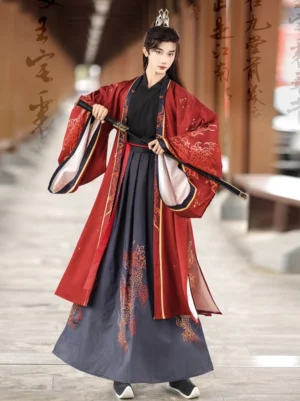 Three-quarter view of red dragon hanfu for men with wide sleeve coat cross-collar layers red sash and sword prop
