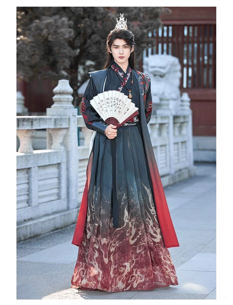 Front portrait of a male model in Crimson Flame ancient Chinese hanfu robe with long red-trimmed vest, flame gradient skirt, cross-collar top, and folding fan