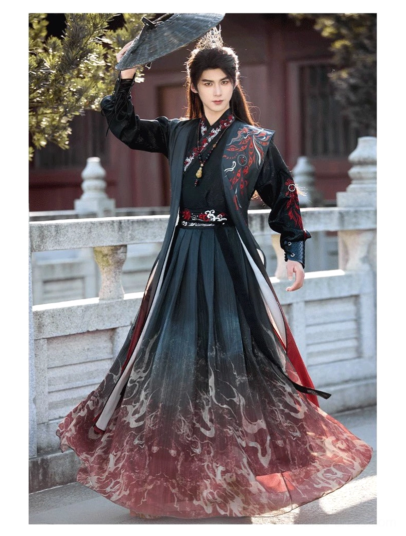 Crimson Flame unisex Wei-Jin style hanfu robe with cross collar, flame gradient skirt, red-trimmed outer vest, and male model holding an oil-paper umbrella on a traditional stone bridge