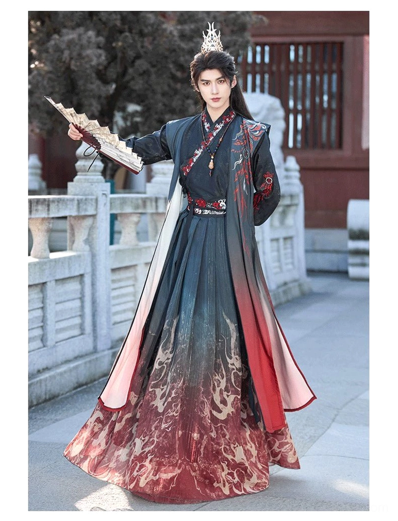 Three-quarter view of a male model wearing Crimson Flame Wei-Jin hanfu with printed gradient hem, red-lined outer vest, embroidered collar, and folding fan