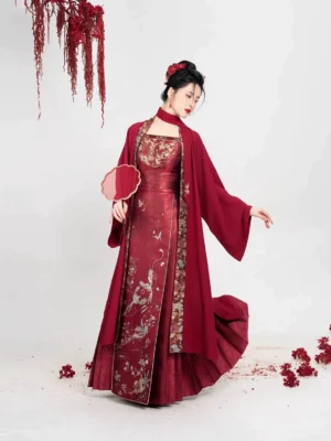 Crimson Magpie Ming Dynasty wedding Hanfu full set shown in a three-quarter studio view with crimson overcoat and embroidered mamian skirt