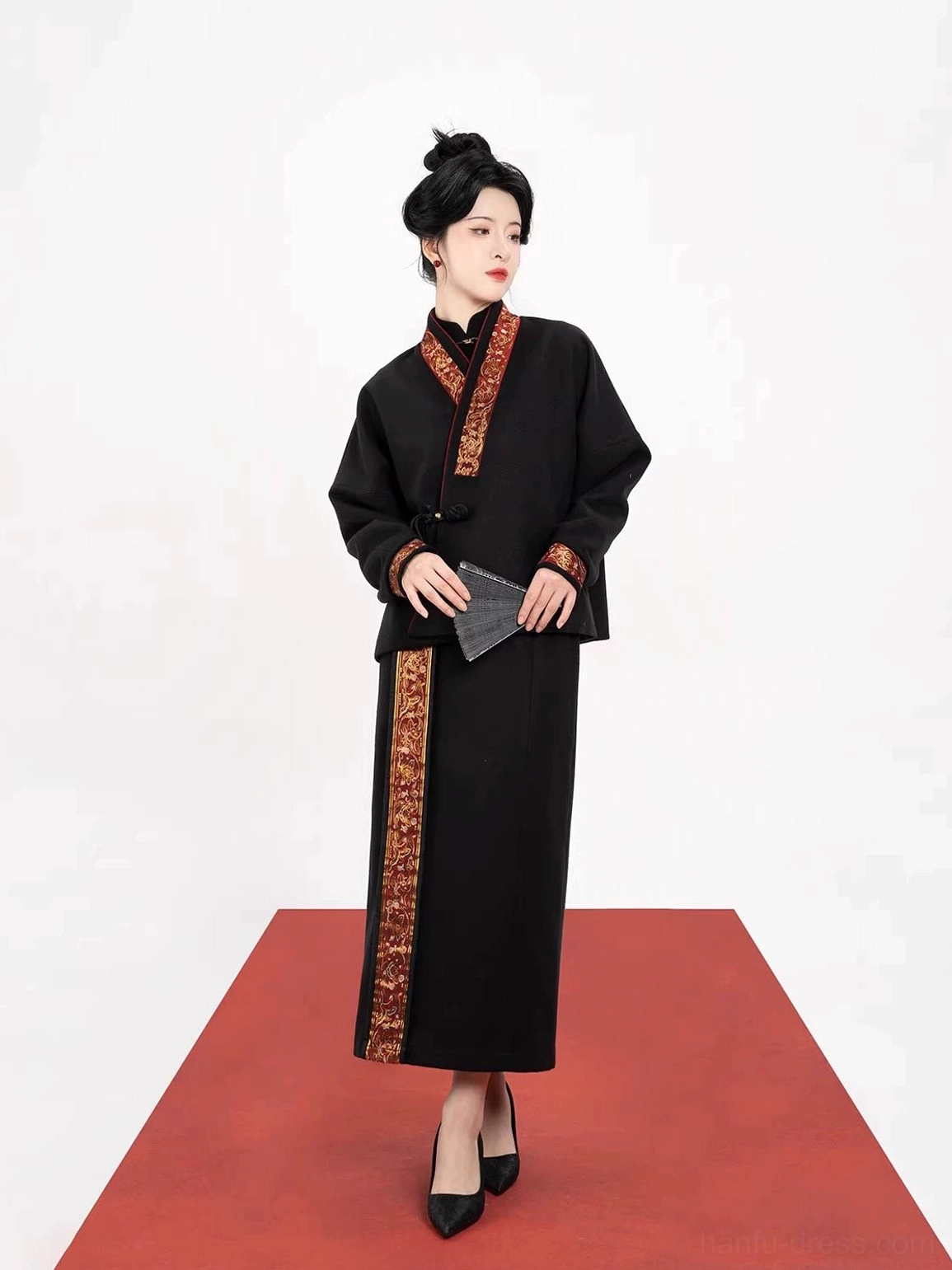 Side view of a cropped black Chinese Hanfu jacket with embroidered collar and cuffs paired with a long skirt