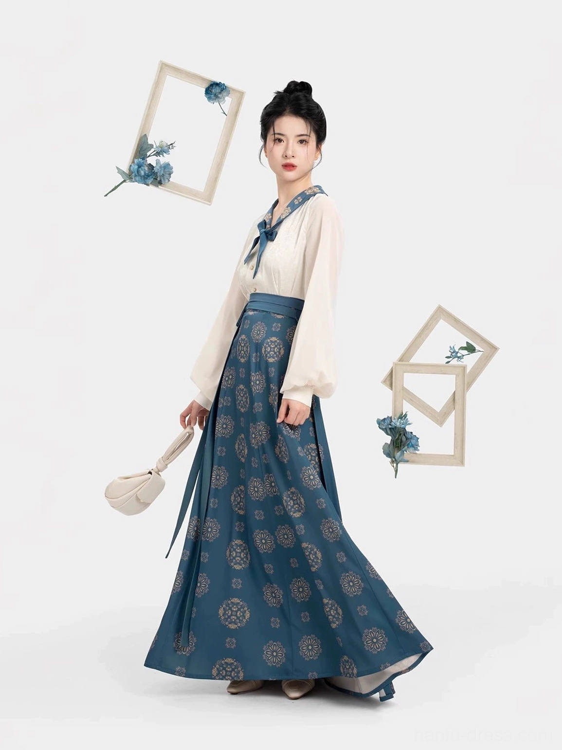 Three-quarter view of a Dailan navy Tang Dynasty hanfu nine-panel skirt with circular golden floral prints, fluid fabric movement, and coordinated cream blouse
